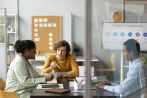 Mentoring session with diverse professionals discussing financial planning.