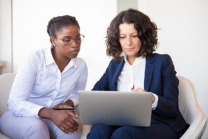 Mentoring session with two women using a laptop for online mentoring | MentorCity.