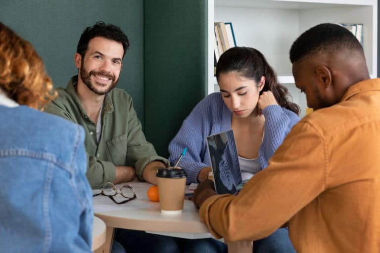 Diverse group of young adults in a mentoring session discussing plans.