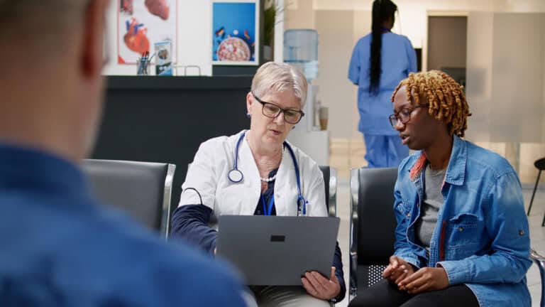 Healthcare professionals engaging in mentoring discussions in a clinical environment.