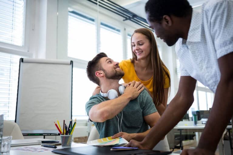 Group mentoring session with diverse participants in a modern office setting.